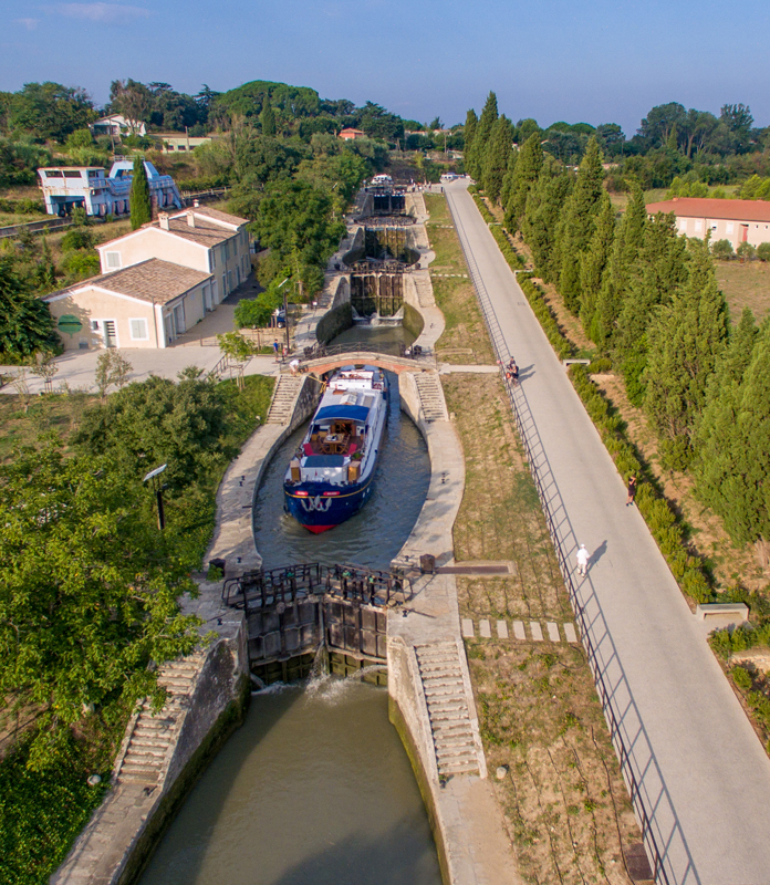 French hotel barge Anjodi cruising the canal du midi - Fonserannes Lock